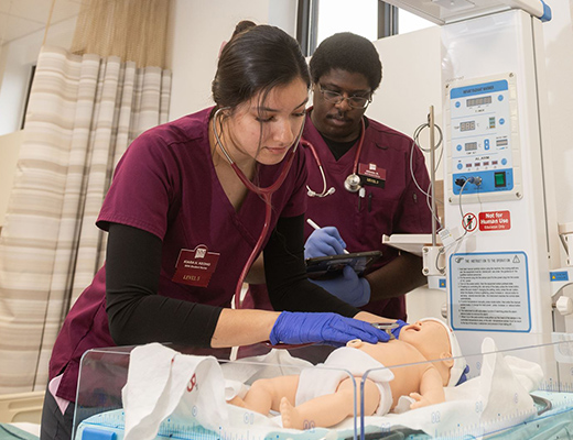 Two Students montering a dummy baby